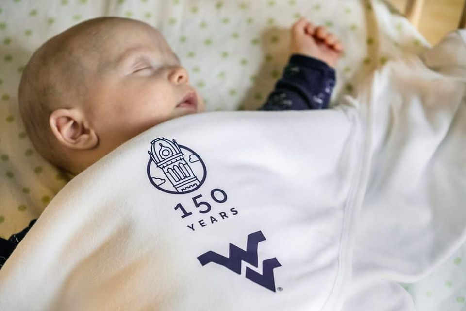 Baby in WVU 150 years blanket