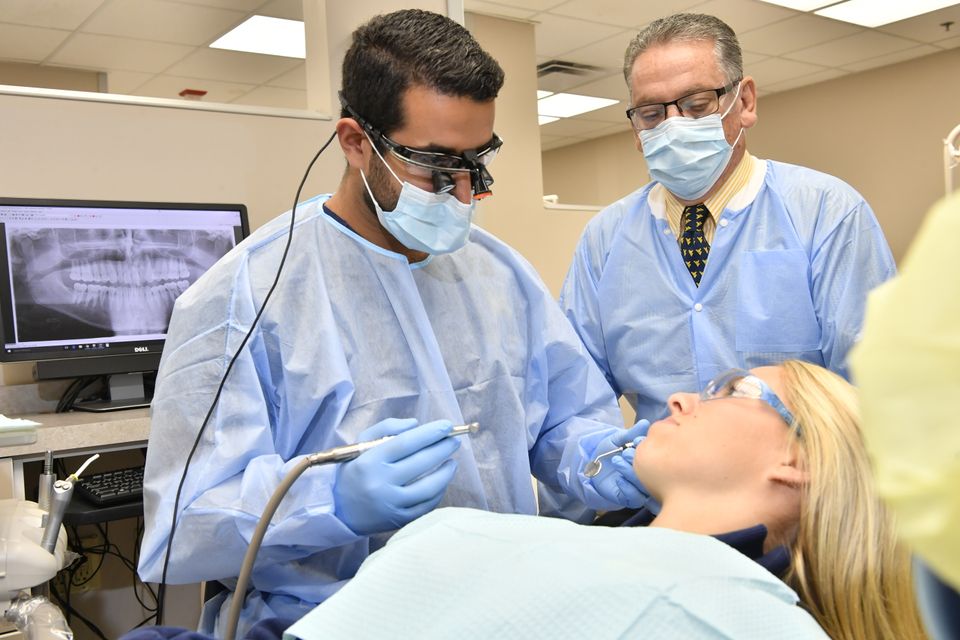 Dentist works with patient