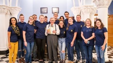 President Gee standing with group of employees