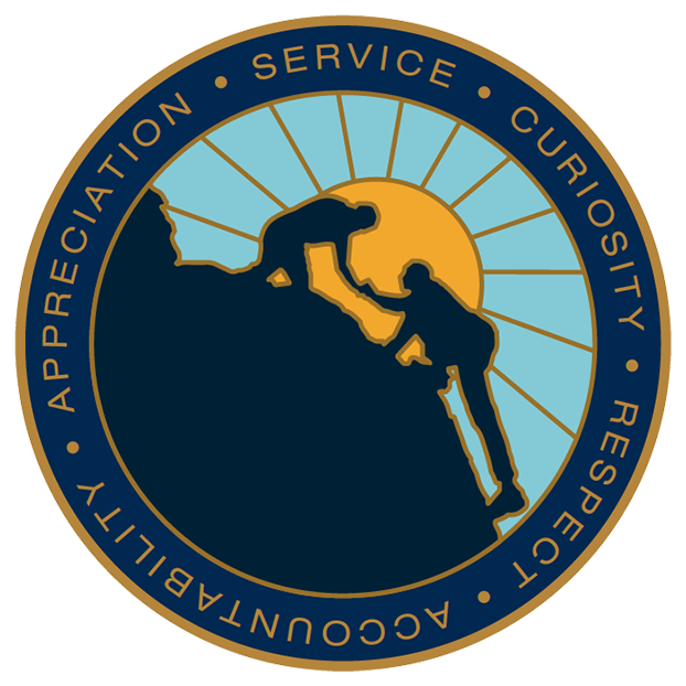 Icon motif of someone helping someone else climb a steep cliff, with a sunrise in the background and Mountaineer Values wrapped around the edge